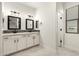Bathroom with double sinks, quartz countertop, black hardware, and modern finishes at 20358 N Valencia N Dr, Maricopa, AZ 85138