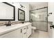 This bathroom features double sinks, modern lighting, and a tiled shower at 20358 N Valencia N Dr, Maricopa, AZ 85138
