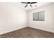 Cozy bedroom with neutral color palette, wood floors, ceiling fan, and natural light at 20358 N Valencia N Dr, Maricopa, AZ 85138