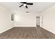 Bedroom features a ceiling fan, wood floors, and natural light at 20358 N Valencia N Dr, Maricopa, AZ 85138
