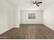A bright bedroom features a large window with natural light and hardwood flooring at 20358 N Valencia N Dr, Maricopa, AZ 85138