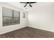 A bright bedroom features a large window with natural light and hardwood flooring at 20358 N Valencia N Dr, Maricopa, AZ 85138