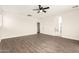 This bedroom includes wood floors, a ceiling fan, and entry to the bathroom at 20358 N Valencia N Dr, Maricopa, AZ 85138