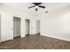 This bedroom features hardwood floors, ample closet space, and neutral paint at 20358 N Valencia N Dr, Maricopa, AZ 85138