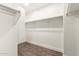 Walk-in closet with wood floors and ample shelving for storage at 20358 N Valencia N Dr, Maricopa, AZ 85138