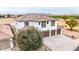 Stunning two-story home featuring a well-manicured lawn and three car garage at 20358 N Valencia N Dr, Maricopa, AZ 85138