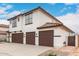 Two-story home featuring a three-car garage, tile roof, and modern design at 20358 N Valencia N Dr, Maricopa, AZ 85138