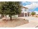 Two-story home featuring a three-car garage, desert landscaping at 20358 N Valencia N Dr, Maricopa, AZ 85138