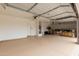 Spacious garage with epoxy floor, ample storage, and an automatic door system for secure and convenient parking at 20358 N Valencia N Dr, Maricopa, AZ 85138