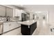 Modern kitchen with stainless steel appliances, white cabinets, black island and backyard views at 20358 N Valencia N Dr, Maricopa, AZ 85138