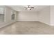 Bright, spacious living room featuring tile floors, three windows and ceiling fan at 20358 N Valencia N Dr, Maricopa, AZ 85138