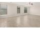 Spacious living room with tile floors and ample natural light from multiple windows at 20358 N Valencia N Dr, Maricopa, AZ 85138
