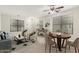 Staged living room with tile floors, recessed lights, and modern decor at 20358 N Valencia N Dr, Maricopa, AZ 85138