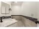 Contemporary powder room with decorative tiled accent, stone countertop, and modern faucet at 20358 N Valencia N Dr, Maricopa, AZ 85138