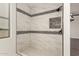 A modern walk-in shower features stylish tile work and elegant fixtures at 20358 N Valencia N Dr, Maricopa, AZ 85138