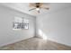 Bright bedroom with a ceiling fan, window with blinds and tile flooring at 2220 W Dora St # 129, Mesa, AZ 85201