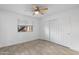 Inviting bedroom with natural light from window, neutral walls, tile flooring, and ceiling fan at 2220 W Dora St # 129, Mesa, AZ 85201