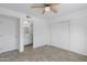 Bedroom featuring tile floors, ceiling fan, closet, and adjoining bathroom at 2220 W Dora St # 129, Mesa, AZ 85201