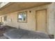 Charming condo exterior featuring a window and doorway with the house number 129 at 2220 W Dora St # 129, Mesa, AZ 85201