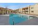 Community pool featuring lounge chairs, BBQ and shade for residents at 2220 W Dora St # 129, Mesa, AZ 85201