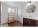 Bathroom featuring a floating vanity, white walls and a tiled walk in shower at 2220 W Surrey Ave, Phoenix, AZ 85029