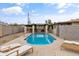 Beautiful backyard featuring a pool, covered patio, and lounge chairs, creating a private oasis at 2220 W Surrey Ave, Phoenix, AZ 85029