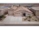 Expansive aerial view of a modern home with three-car garage and well-manicured landscaping in a residential neighborhood at 24757 N 175 Dr, Surprise, AZ 85387