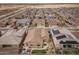Stunning aerial view of a neighborhood showcasing well-maintained homes with desert landscaping and solar panels at 24757 N 175 Dr, Surprise, AZ 85387