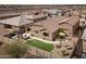 An aerial shot captures a backyard oasis with a patio, comfortable seating, fire pit, and a neat artificial grass area at 24757 N 175 Dr, Surprise, AZ 85387