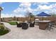 Relaxing backyard with outdoor bar, grill, and chairs, perfect for entertaining guests at 24757 N 175 Dr, Surprise, AZ 85387