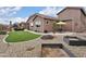 Inviting backyard showcasing manicured landscaping, rock features, and a cozy patio area perfect for outdoor gatherings at 24757 N 175 Dr, Surprise, AZ 85387