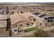 A beautiful aerial view of the backyard featuring a patio with a cozy fire pit and seating area and artificial grass at 24757 N 175 Dr, Surprise, AZ 85387