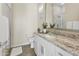 Well-lit bathroom with granite countertop, decorative mirror, and walk-in shower at 24757 N 175 Dr, Surprise, AZ 85387