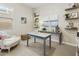 Bright bedroom with decorations, shelves, and a comfortable armchair near a window at 24757 N 175 Dr, Surprise, AZ 85387