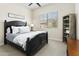 Comfortable bedroom with dark wood furniture, plush bedding, window view, and bedside table with lamp at 24757 N 175 Dr, Surprise, AZ 85387