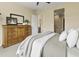 Comfortable bedroom featuring a dresser, plush bedding, and view into the bathroom and hallway at 24757 N 175 Dr, Surprise, AZ 85387