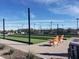 An inviting recreation area featuring bocce ball courts, comfortable seating, and ambient string lights for evening enjoyment at 24757 N 175 Dr, Surprise, AZ 85387