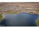 Scenic aerial shot of a lakeside community featuring modern homes, a community pool, and recreational facilities at 24757 N 175 Dr, Surprise, AZ 85387