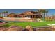 Scenic shot of the clubhouse with a miniature golf course, offering recreational fun and luxurious community amenities at 24757 N 175 Dr, Surprise, AZ 85387