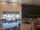 A spacious community room with tables, chairs, and a stage for gatherings and events at 24757 N 175 Dr, Surprise, AZ 85387