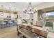Open-concept living space featuring dining area, kitchen with island seating, and cozy living room at 24757 N 175 Dr, Surprise, AZ 85387