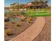 A lush community outdoor area featuring a putting green, lake, and community building at 24757 N 175 Dr, Surprise, AZ 85387