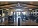 A bright gym featuring modern exercise equipment, ceiling fans, and lake views at 24757 N 175 Dr, Surprise, AZ 85387