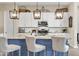 Well-equipped kitchen with a large island, white cabinets, and pendant lighting at 24757 N 175 Dr, Surprise, AZ 85387