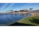 A picturesque view of a community clubhouse by the lake, reflecting a serene and inviting atmosphere at 24757 N 175 Dr, Surprise, AZ 85387