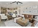 Open-concept living room with a leather sofa, elegant seating, and an adjacent kitchen at 24757 N 175 Dr, Surprise, AZ 85387