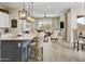 Open-concept living space with a kitchen island, a cozy seating area, and modern finishes at 24757 N 175 Dr, Surprise, AZ 85387