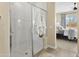 Bright walk-in shower features white subway tile and glass door with attached towel bars at 24757 N 175 Dr, Surprise, AZ 85387