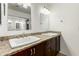 Bathroom featuring a double sink vanity with granite countertops and dark wood cabinetry for ample storage at 2875 W Highland St # 1213, Chandler, AZ 85224