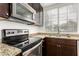 Close-up of a kitchen with granite countertops and stainless steel appliances at 2875 W Highland St # 1213, Chandler, AZ 85224